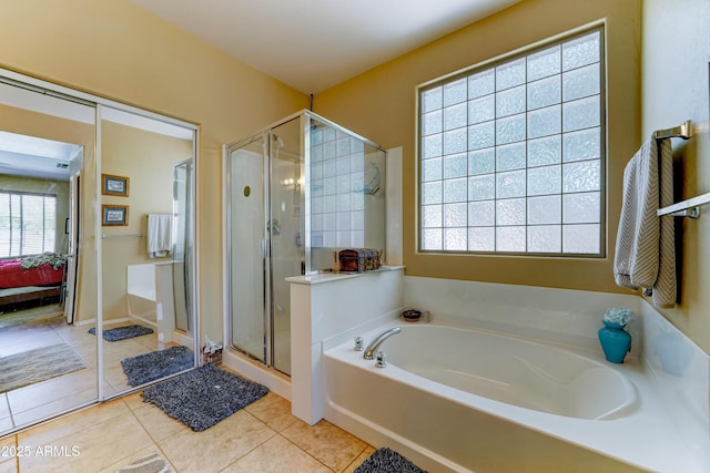 7815 S 22nd Ln, Phoenix, AZ 85041 - ensuite bathroom with tile patterned floors, a bath, and a shower stall