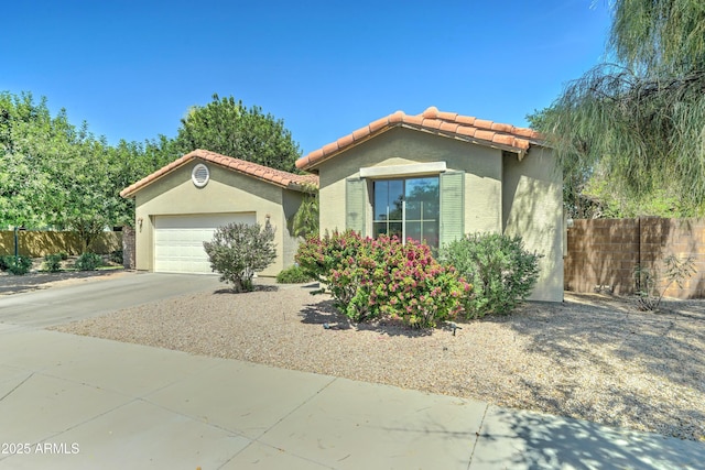 7815 S 22nd Ln, Phoenix, AZ 85041 - view of front of house featuring a tile roof, an attached garage, stucco siding, fence, and concrete driveway