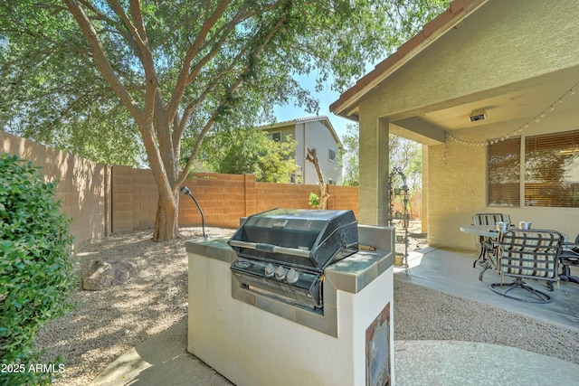 7815 S 22nd Ln, Phoenix, AZ 85041 - view of patio with a fenced backyard, an outdoor kitchen, and grilling area