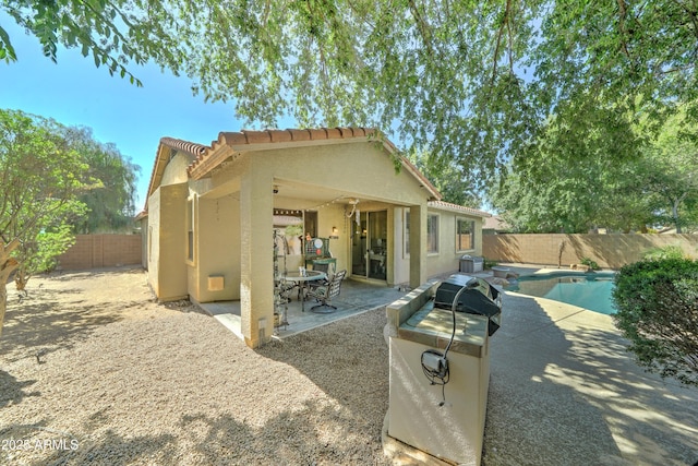 7815 S 22nd Ln, Phoenix, AZ 85041 - back of property featuring stucco siding, a fenced backyard, a patio, and a tile roof