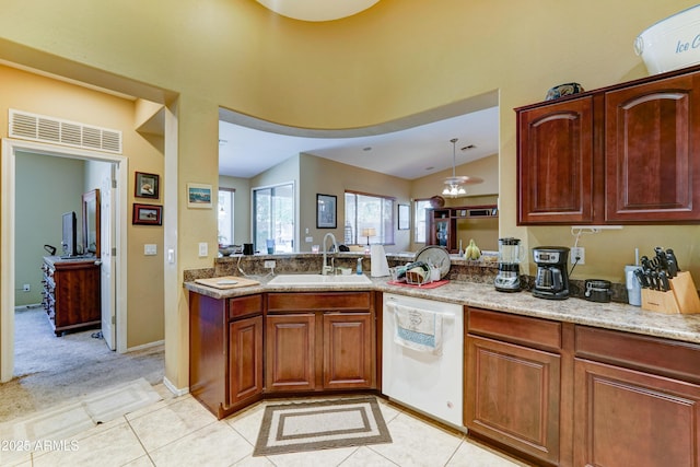 7815 S 22nd Ln, Phoenix, AZ 85041 - kitchen with dishwasher, a sink, a peninsula, light tile patterned floors, and lofted ceiling