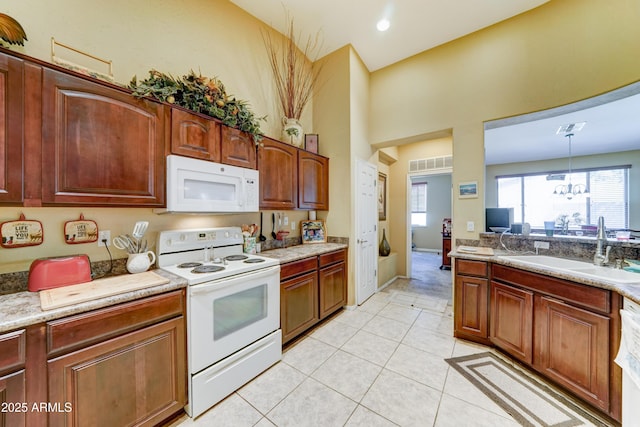 7815 S 22nd Ln, Phoenix, AZ 85041 - kitchen with white appliances, a sink, light tile patterned floors, and light countertops