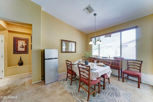 7815 S 22nd Ln, Phoenix, AZ 85041 - carpeted dining space featuring healthy amount of natural light, vaulted ceiling, a chandelier, and baseboards