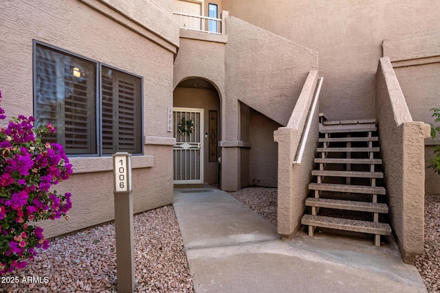 doorway to property featuring stucco siding