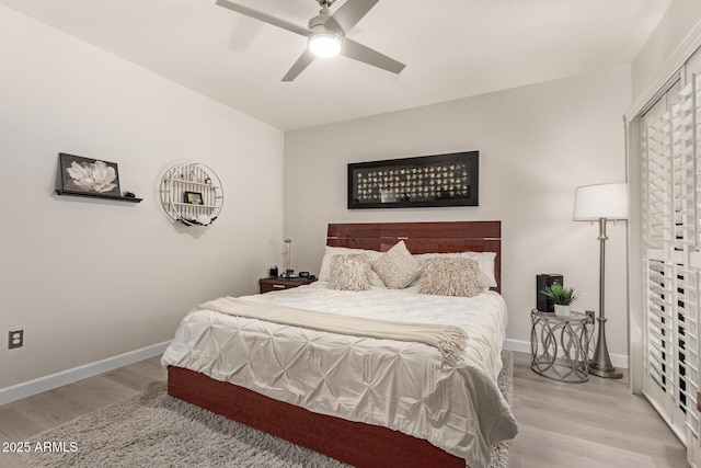 bedroom featuring light wood-type flooring, ceiling fan, and baseboards