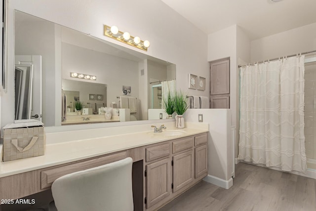 full bath with curtained shower, wood finished floors, and vanity