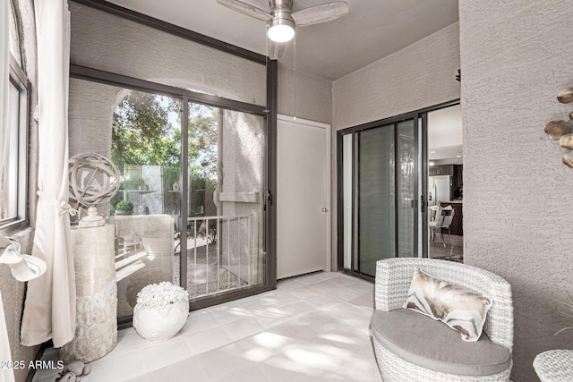 sunroom with a ceiling fan