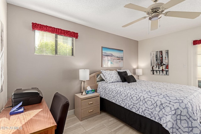 bedroom with a textured ceiling and ceiling fan