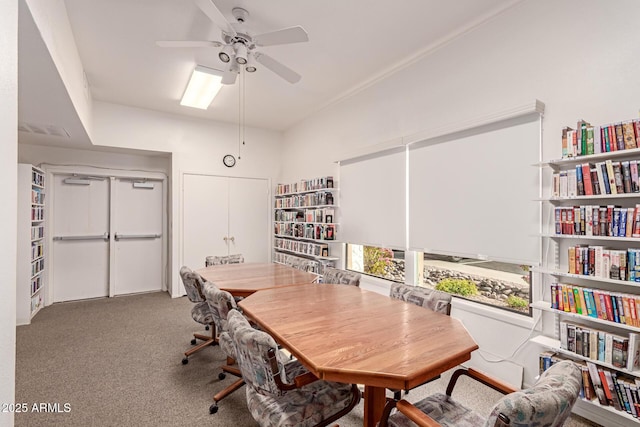 carpeted office space with ceiling fan