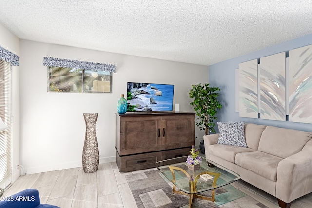 living room featuring a healthy amount of sunlight and a textured ceiling