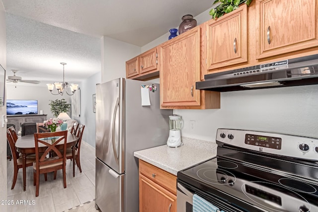 kitchen with ceiling fan with notable chandelier, pendant lighting, stainless steel appliances, light brown cabinets, and a textured ceiling