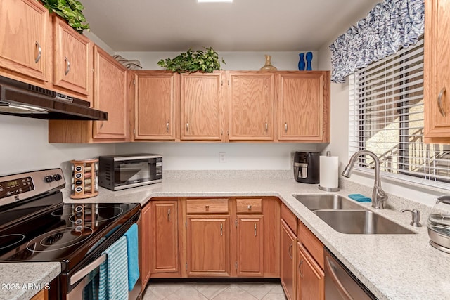 kitchen with sink, light tile patterned flooring, and appliances with stainless steel finishes