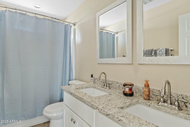 bathroom featuring vanity, curtained shower, and toilet