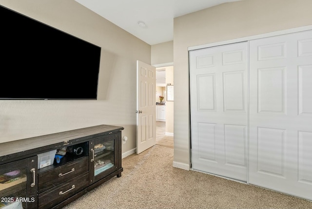 carpeted bedroom with a closet