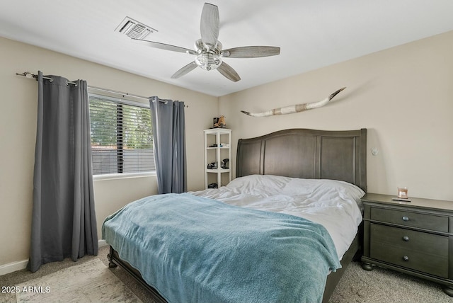 bedroom featuring light colored carpet and ceiling fan