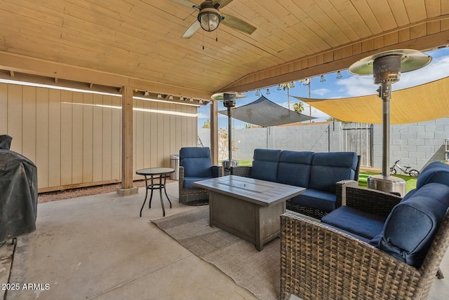 view of patio featuring grilling area, an outdoor living space with a fire pit, and ceiling fan