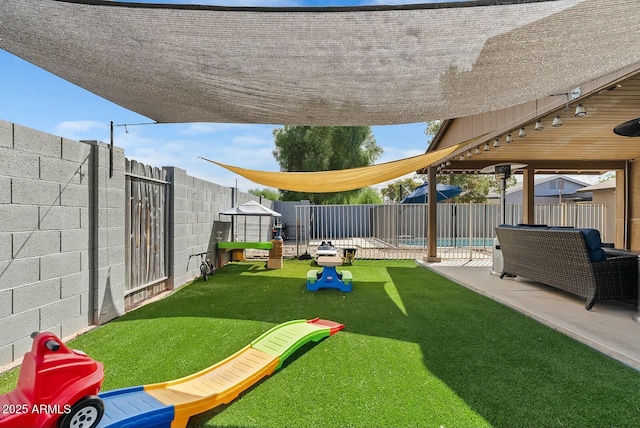 view of yard with a patio and a swimming pool