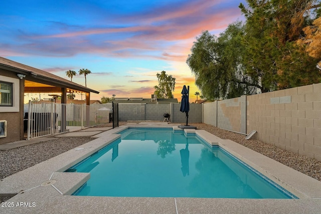 view of pool at dusk