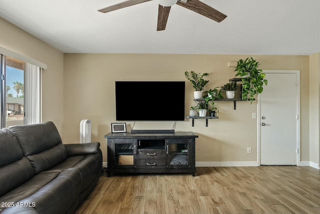 living room featuring ceiling fan and light wood-type flooring