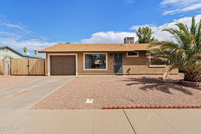 view of front of home featuring a garage and central AC