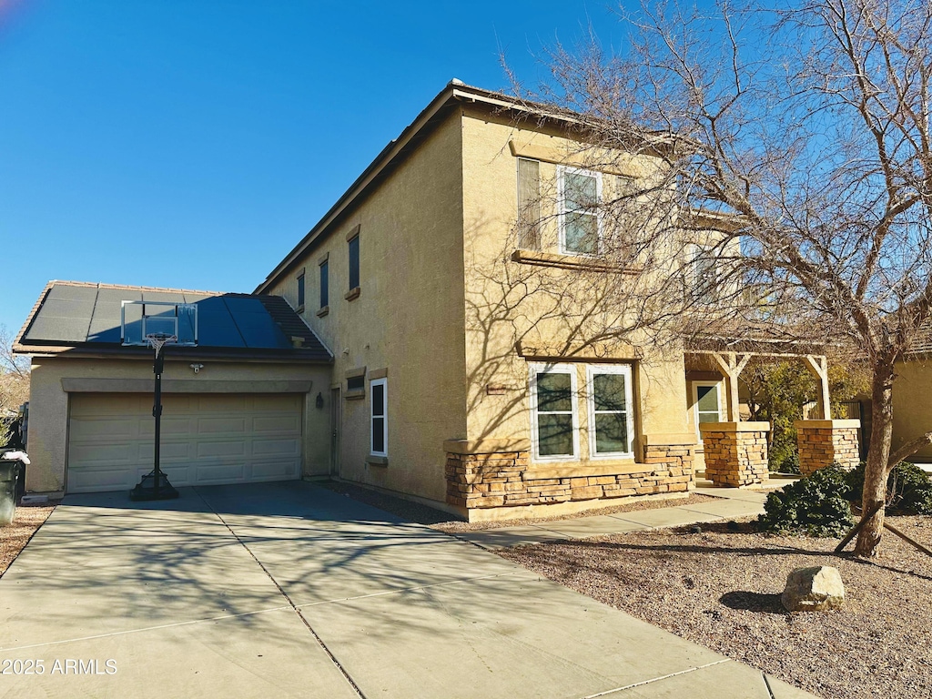 view of front of home featuring a garage and solar panels