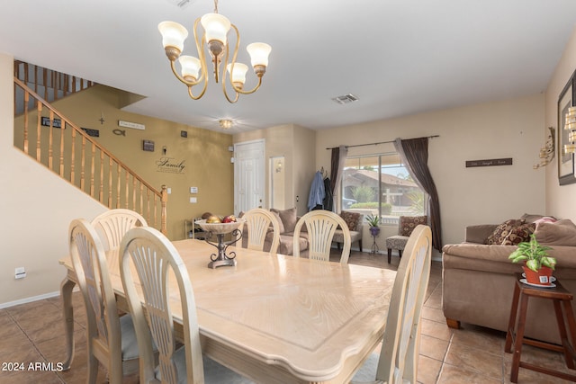 tiled dining room with a chandelier