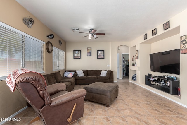 living room featuring ceiling fan and light tile patterned floors