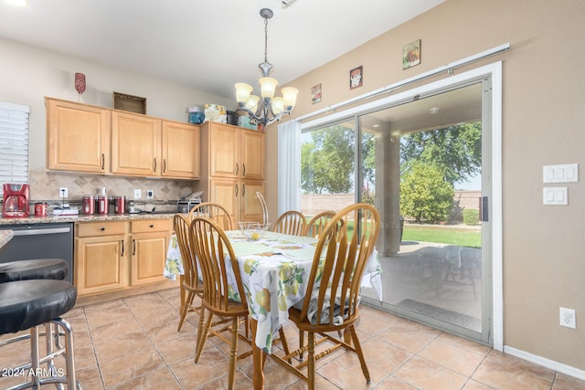 tiled dining room with an inviting chandelier