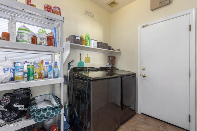 laundry room with light tile patterned flooring and separate washer and dryer