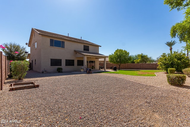 rear view of house featuring a patio