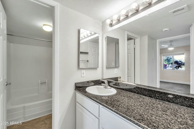 bathroom with tile patterned floors, shower / washtub combination, and vanity