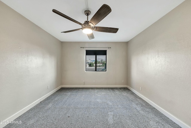 empty room featuring ceiling fan and carpet floors