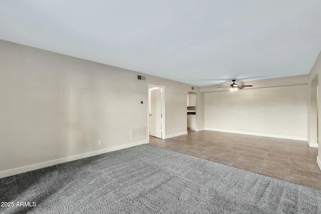 unfurnished room with carpet floors and ceiling fan