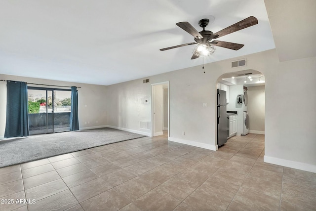 tiled spare room with ceiling fan