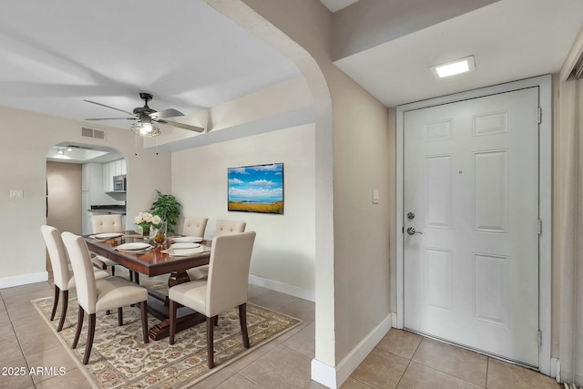 tiled dining area with ceiling fan