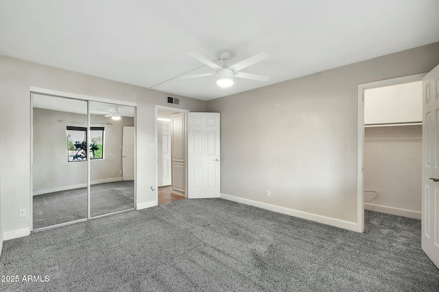 unfurnished bedroom with dark carpet and ceiling fan