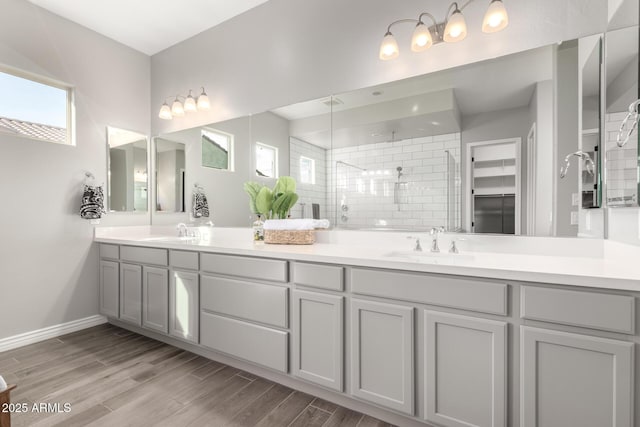 bathroom with vanity and a tile shower