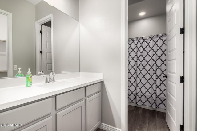 bathroom featuring vanity and curtained shower