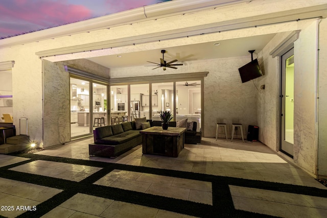 patio terrace at dusk with ceiling fan and outdoor lounge area