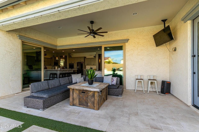 view of patio with outdoor lounge area and ceiling fan