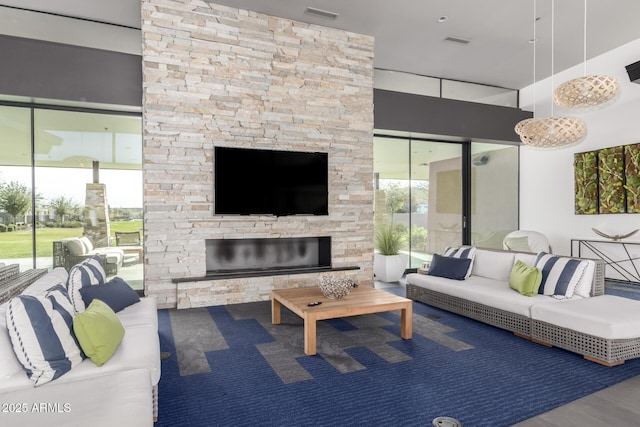 living room featuring an outdoor stone fireplace