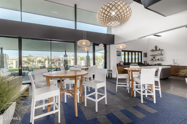 dining space featuring a towering ceiling