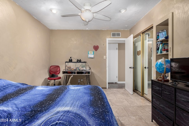 tiled bedroom with a closet and ceiling fan