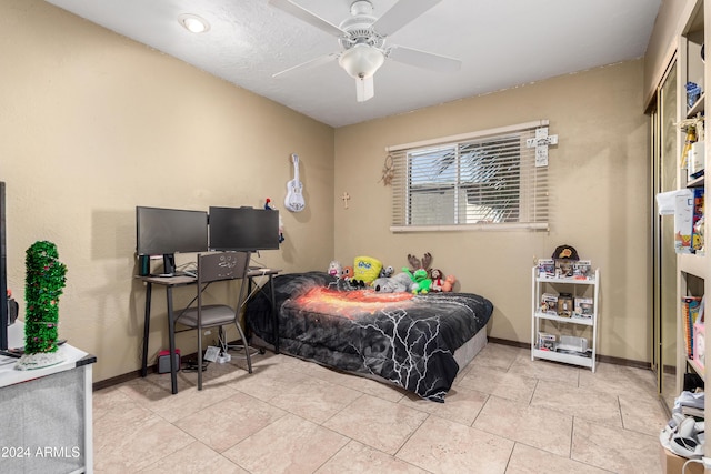 bedroom with ceiling fan and light tile patterned flooring