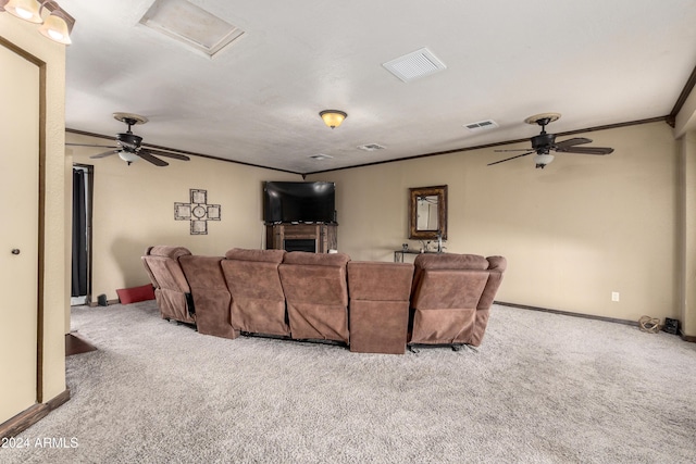 cinema featuring a fireplace, light colored carpet, and crown molding