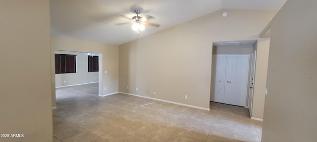 spare room with light tile patterned floors, baseboards, a ceiling fan, and lofted ceiling