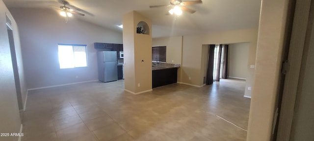 kitchen featuring white appliances, ceiling fan, baseboards, and high vaulted ceiling