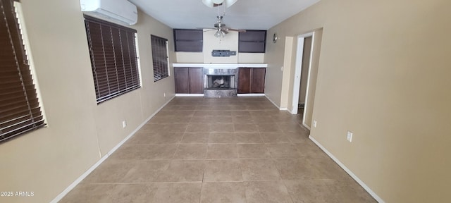 corridor featuring baseboards, a wall unit AC, and light tile patterned floors