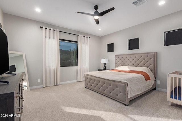 bedroom featuring light carpet and ceiling fan