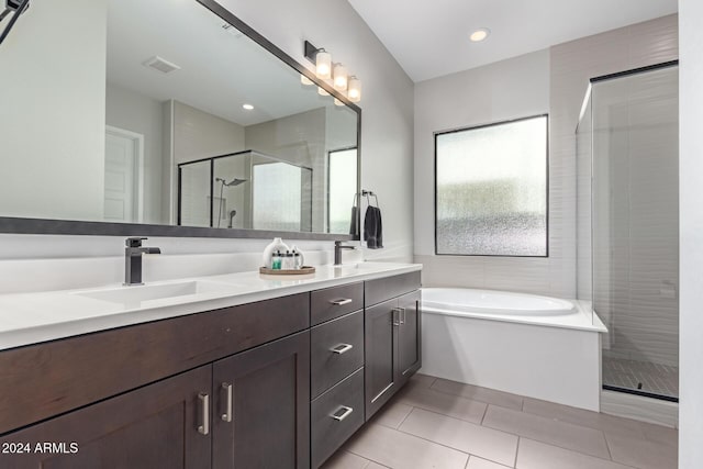 bathroom with tile patterned floors, vanity, and independent shower and bath